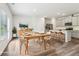 Staged dining area connected to a modern kitchen with stainless steel appliances at 2762 Aralynn Way, College Park, GA 30337