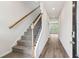 Welcoming entryway with gray carpeted stairs and wood-look floors, complemented by modern lighting at 2762 Aralynn Way, College Park, GA 30337