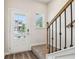 Bright entryway with staircase, featuring modern lighting and a front door with glass panes at 2762 Aralynn Way, College Park, GA 30337
