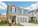 Beautiful home with gray siding, white trim, a black front door, and a spacious three-car gray garage at 2762 Aralynn Way, College Park, GA 30337