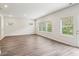 Bright, open-concept living room featuring hard wood floors and large windows with views of the backyard at 2762 Aralynn Way, College Park, GA 30337