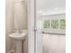 Stylish powder room featuring pedestal sink, with views of the great room through the doorway at 2762 Aralynn Way, College Park, GA 30337