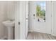 Modern pedestal sink and lavatory in a well-lit bathroom with neutral wall and flooring tones at 2764 Aralynn Way, College Park, GA 30337