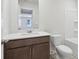 Bathroom featuring a white vanity countertop, brown cabinets, and toilet, and a shower and tub at 2764 Aralynn Way, College Park, GA 30337