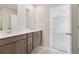 Bathroom featuring a double vanity, modern cabinetry, and a doorway to the bedroom at 2764 Aralynn Way, College Park, GA 30337