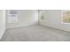 Spacious bedroom with plush gray carpeting and plenty of natural light from three windows at 2764 Aralynn Way, College Park, GA 30337
