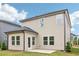 Home exterior with beige siding, black roof, and a small backyard patio with green lawn at 2764 Aralynn Way, College Park, GA 30337