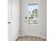 Bright white front door with decorative glass panels, providing natural light at 2764 Aralynn Way, College Park, GA 30337