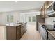 Well-lit kitchen showcases stainless appliances and granite counters, open to the dining area at 2764 Aralynn Way, College Park, GA 30337