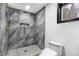 Modern bathroom featuring a large shower with gold fixtures and sleek gray stone-look tiling at 3661 W Potomac Dr, East Point, GA 30344