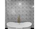 Designer bathroom with soaking tub, modern gold fixtures, and graphic tile wall at 3661 W Potomac Dr, East Point, GA 30344