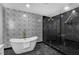 Bright bathroom with soaking tub, glass shower, modern fixtures, and designer tile at 3661 W Potomac Dr, East Point, GA 30344