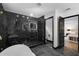 Designer bathroom with soaking tub, marble shower, modern fixtures, and dark trim at 3661 W Potomac Dr, East Point, GA 30344