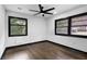 Bright bedroom featuring hardwood floors, neutral walls, and black trim windows with outside view at 3661 W Potomac Dr, East Point, GA 30344