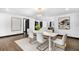 Bright dining room with modern chandelier, stylish decor, and seamless flow to the open kitchen at 3661 W Potomac Dr, East Point, GA 30344