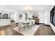 Chic dining area featuring a designer light fixture and contemporary furnishings, adjacent to kitchen at 3661 W Potomac Dr, East Point, GA 30344