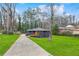 Beautiful house showcasing a lush green lawn and a long driveway leading up to the home at 3661 W Potomac Dr, East Point, GA 30344