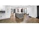 Open kitchen area with island, dark wood floors, and a view of the dining room at 3661 W Potomac Dr, East Point, GA 30344
