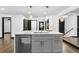 Kitchen island with quartz countertop, stainless steel dishwasher, and stylish pendant lighting at 3661 W Potomac Dr, East Point, GA 30344
