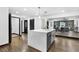 Spacious kitchen island with white countertop, gray cabinets, and elegant pendant lighting at 3661 W Potomac Dr, East Point, GA 30344