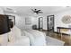 Bright main bedroom with dark trim, wood floors, ceiling fan, ensuite bathroom, and walk in closet at 3661 W Potomac Dr, East Point, GA 30344