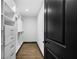 A bright walk-in closet with custom shelving and drawers, plus wood flooring at 3661 W Potomac Dr, East Point, GA 30344