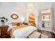 Bright bedroom featuring wood floors, stylish décor, and an ensuite bathroom separated by curtains at 105 Park Ridge Cir, Marietta, GA 30068