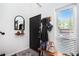 Inviting entryway with a black door, stylish mirror, and coat rack for organized convenience at 105 Park Ridge Cir, Marietta, GA 30068