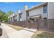 View of the townhome's side, with a sidewalk, fence, and lush trees offering privacy and charm at 105 Park Ridge Cir, Marietta, GA 30068