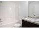 Bright bathroom featuring a shower-tub combo and vanity with granite countertop at 3095 Bonnes Dr, Lithonia, GA 30038