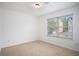 Cozy bedroom with carpet flooring, natural light from the window and fresh white walls at 3095 Bonnes Dr, Lithonia, GA 30038