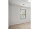 Bright bedroom with neutral carpet, white walls, and a large window offering natural light at 3095 Bonnes Dr, Lithonia, GA 30038