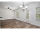 Dining area with hardwood floors, abundant natural light, and a modern chandelier at 3095 Bonnes Dr, Lithonia, GA 30038