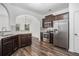 Modern kitchen with stainless steel appliances, granite countertops, and dark wood cabinetry at 3095 Bonnes Dr, Lithonia, GA 30038