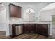 Kitchen with stainless steel dishwasher, granite countertops, and dark wood cabinets at 3095 Bonnes Dr, Lithonia, GA 30038