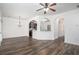 Bright living room featuring dark hardwood floors, white walls, and elegant archway transitions at 3095 Bonnes Dr, Lithonia, GA 30038
