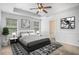 Main bedroom featuring a tray ceiling, modern decor, and an en-suite bath at 3095 Bonnes Dr, Lithonia, GA 30038