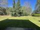 Spacious backyard with lush green lawn, mature trees, and ample sunlight at 3108 Broadleaf Trl, Fairburn, GA 30213