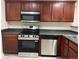 Functional kitchen featuring stainless steel appliances and sleek dark countertops at 3108 Broadleaf Trl, Fairburn, GA 30213