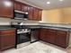 Well-equipped kitchen features stainless steel appliances, spacious countertop and dark wood cabinetry at 3108 Broadleaf Trl, Fairburn, GA 30213