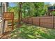 Spacious backyard with a wooden fence, grassy area, and a wooden deck at 682 Shelton Sw Ave, Atlanta, GA 30310