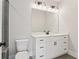 Bathroom featuring a white vanity, granite countertop, and vanity lights at 682 Shelton Sw Ave, Atlanta, GA 30310