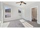 Sunlit bedroom with windows and an open doorway to the bathroom featuring carpet flooring at 682 Shelton Sw Ave, Atlanta, GA 30310