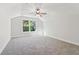 Vaulted bedroom with large windows overlooking greenery, carpeted flooring, and neutral paint at 682 Shelton Sw Ave, Atlanta, GA 30310