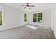 Bedroom featuring plush carpet, ceiling fan, and large windows at 682 Shelton Sw Ave, Atlanta, GA 30310
