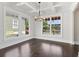 Bright dining room with coffered ceiling and large windows overlooking the landscaped yard at 682 Shelton Sw Ave, Atlanta, GA 30310