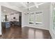 Bright dining area connected to a kitchen with coffered ceilings and hardwood floors at 682 Shelton Sw Ave, Atlanta, GA 30310