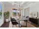 Elegant dining area featuring coffered ceilings, large windows, and modern chandelier at 682 Shelton Sw Ave, Atlanta, GA 30310