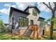 View of the backyard with a deck and a modern two-story home featuring gray siding and brick foundation at 682 Shelton Sw Ave, Atlanta, GA 30310