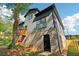 View of the backyard with a deck and a modern two-story home featuring gray siding and brick foundation at 682 Shelton Sw Ave, Atlanta, GA 30310